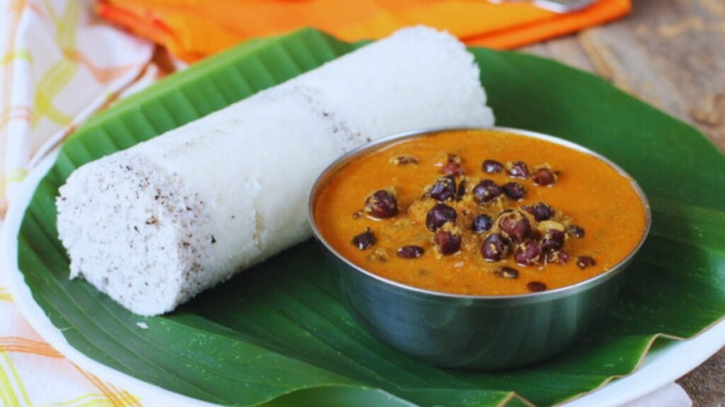 Puttu and Kadala curry being served over a banana leaf